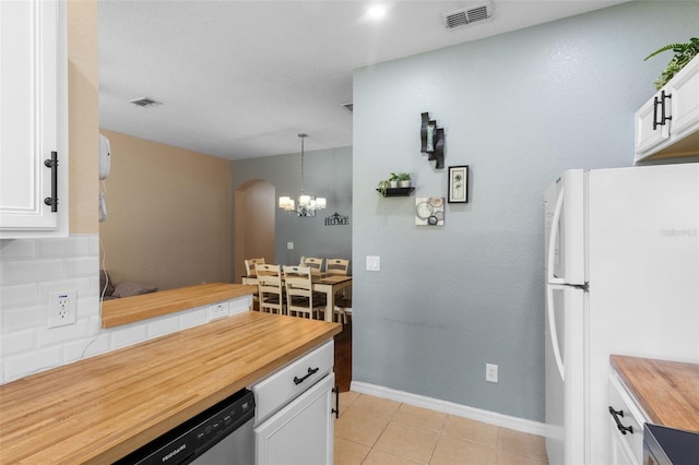 624 Terra Lago St, Davenport, FL 33897 - kitchen with wooden counters, freestanding refrigerator, white cabinetry, and dishwasher