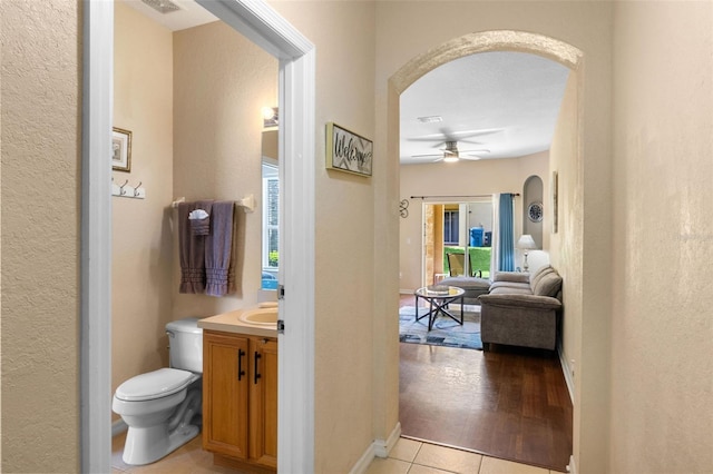 624 Terra Lago St, Davenport, FL 33897 - hall with arched walkways, light tile patterned flooring, and a textured wall