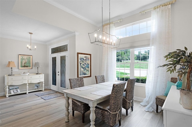 6136 Lake Emma Rd, Groveland, FL 34736 - dining room featuring a chandelier, ornamental molding, and light wood finished floors