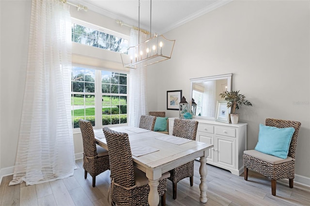 6136 Lake Emma Rd, Groveland, FL 34736 - dining room featuring a chandelier, ornamental molding, light wood finished floors, and a high ceiling