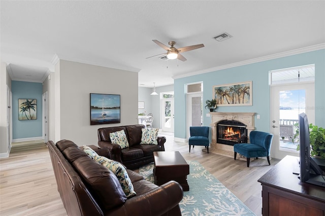 6136 Lake Emma Rd, Groveland, FL 34736 - living area featuring crown molding, a ceiling fan, light wood finished floors, and a fireplace