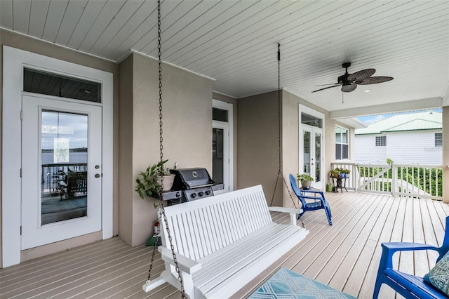 6136 Lake Emma Rd, Groveland, FL 34736 - wooden deck with ceiling fan and french doors