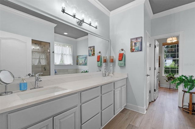 6136 Lake Emma Rd, Groveland, FL 34736 - bathroom featuring double vanity, a shower stall, ornamental molding, healthy amount of natural light, and wood finished floors