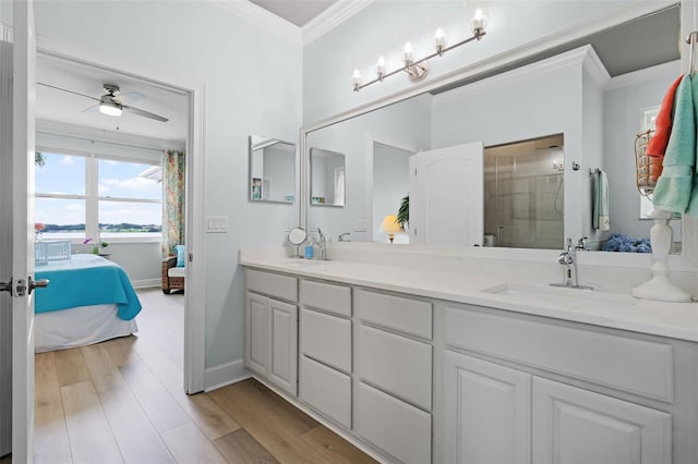 6136 Lake Emma Rd, Groveland, FL 34736 - full bath featuring connected bathroom, double vanity, ornamental molding, ceiling fan, and wood finished floors
