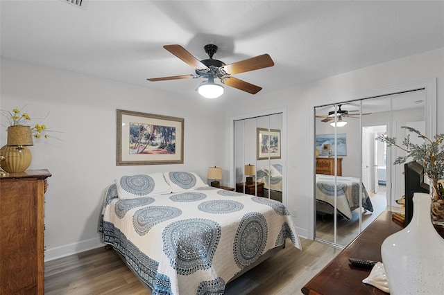 6136 Lake Emma Rd, Groveland, FL 34736 - bedroom featuring multiple closets, wood finished floors, and a ceiling fan