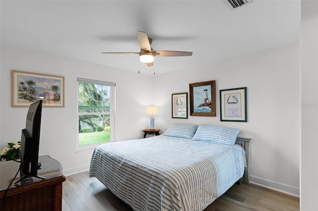 6136 Lake Emma Rd, Groveland, FL 34736 - bedroom with wood finished floors and a ceiling fan