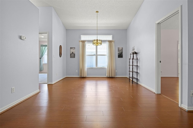 5507 Laver St, Leesburg, FL 34748 - unfurnished dining area featuring a chandelier, a textured ceiling, and wood finished floors