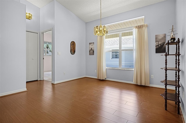 5507 Laver St, Leesburg, FL 34748 - unfurnished room featuring a chandelier, wood finished floors, and a textured ceiling