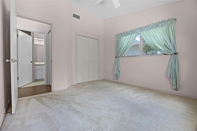 5507 Laver St, Leesburg, FL 34748 - unfurnished bedroom featuring carpet, a closet, ceiling fan, and a textured ceiling