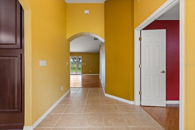 5729 Bible Camp Rd, Groveland, FL 34736 - hall featuring arched walkways, light tile patterned floors, and a textured wall