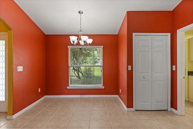 5729 Bible Camp Rd, Groveland, FL 34736 - unfurnished dining area featuring a chandelier, arched walkways, and light tile patterned floors