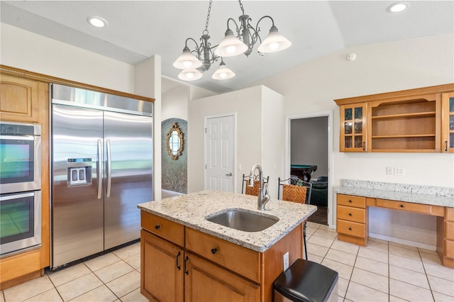 81 N Carol Ave, Mascotte, FL 34753 - kitchen featuring appliances with stainless steel finishes, open shelves, light tile patterned floors, an island with sink, and vaulted ceiling