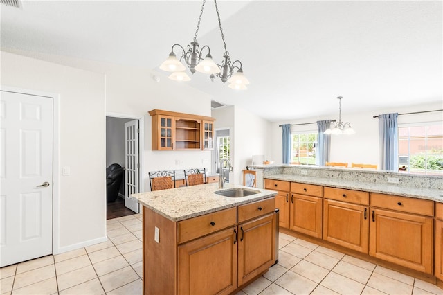 81 N Carol Ave, Mascotte, FL 34753 - kitchen with a chandelier, light tile patterned floors, pendant lighting, light stone counters, and vaulted ceiling