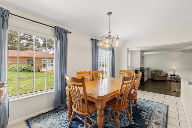 81 N Carol Ave, Mascotte, FL 34753 - dining space with a chandelier, lofted ceiling, and light tile patterned floors