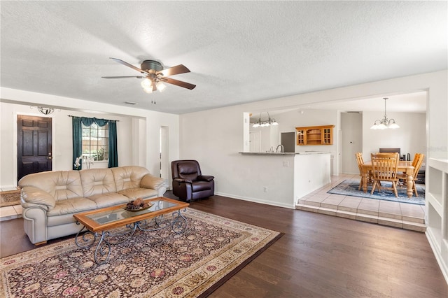 81 N Carol Ave, Mascotte, FL 34753 - living area with a textured ceiling, wood finished floors, a ceiling fan, and a chandelier
