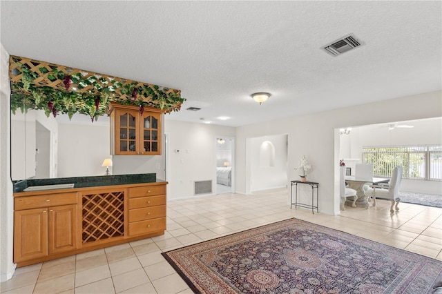 81 N Carol Ave, Mascotte, FL 34753 - bar with light tile patterned floors, a textured ceiling, and ceiling fan