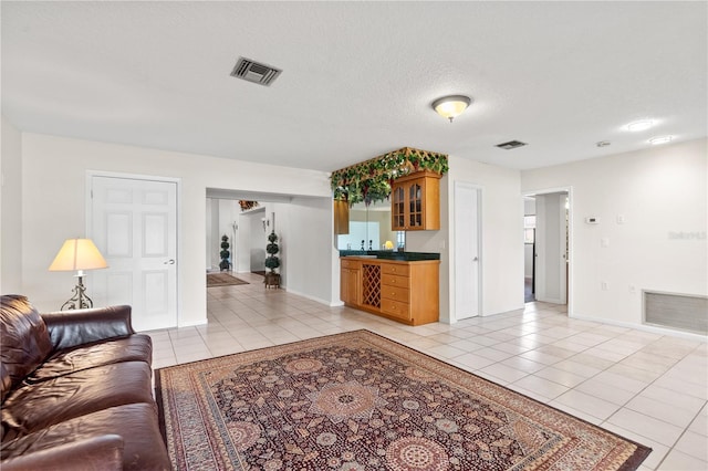 81 N Carol Ave, Mascotte, FL 34753 - living room with light tile patterned floors and bar area