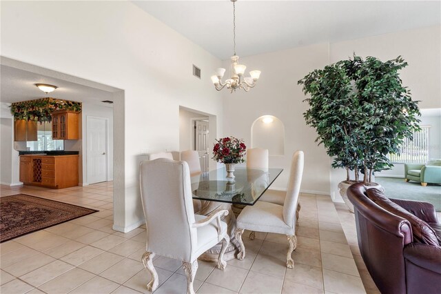 81 N Carol Ave, Mascotte, FL 34753 - dining space featuring light tile patterned floors, a chandelier, and a towering ceiling