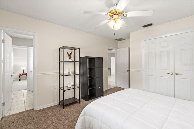 81 N Carol Ave, Mascotte, FL 34753 - carpeted bedroom with a closet, ceiling fan, and tile patterned flooring