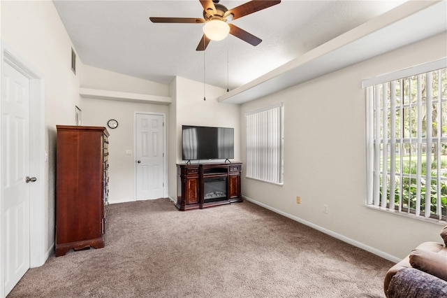 81 N Carol Ave, Mascotte, FL 34753 - living area featuring ceiling fan, plenty of natural light, carpet floors, and vaulted ceiling
