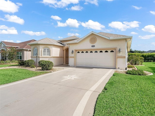 10927 SE 168th Loop, Summerfield, FL 34491 - view of front of property featuring an attached garage, stucco siding, driveway, and a front lawn