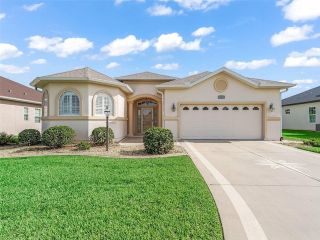 10927 SE 168th Loop, Summerfield, FL 34491 - mediterranean / spanish house featuring stucco siding, concrete driveway, a front yard, and an attached garage