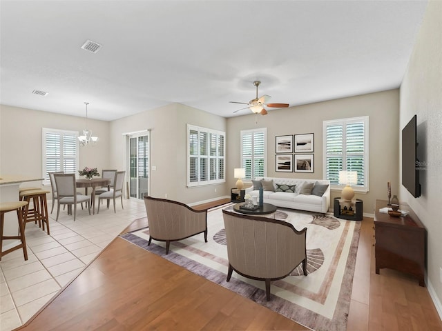 10927 SE 168th Loop, Summerfield, FL 34491 - living area with a chandelier, ceiling fan, and light wood-style floors