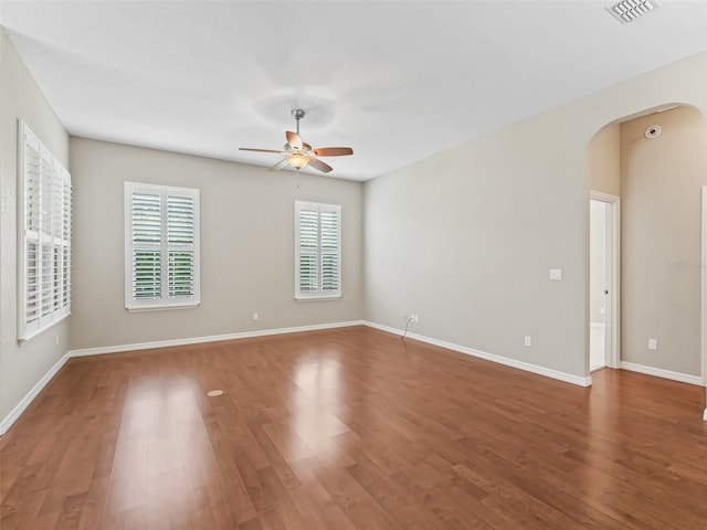 10927 SE 168th Loop, Summerfield, FL 34491 - empty room with arched walkways, ceiling fan, and wood finished floors