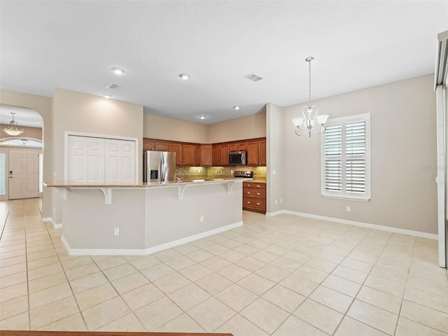 10927 SE 168th Loop, Summerfield, FL 34491 - kitchen featuring appliances with stainless steel finishes, a chandelier, light countertops, light tile patterned floors, and recessed lighting
