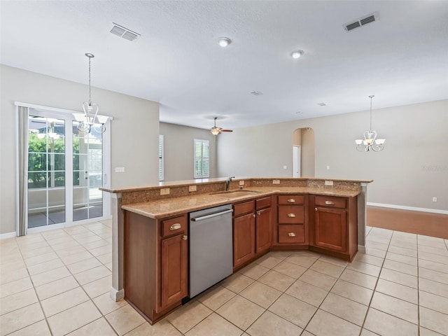 10927 SE 168th Loop, Summerfield, FL 34491 - kitchen featuring a chandelier, dishwasher, light tile patterned flooring, and brown cabinetry