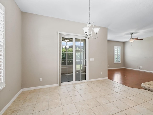 10927 SE 168th Loop, Summerfield, FL 34491 - spare room featuring ceiling fan, a chandelier, and light tile patterned flooring