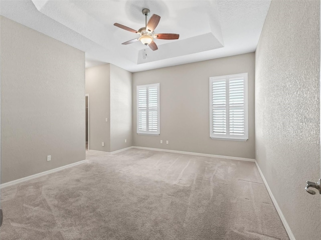 10927 SE 168th Loop, Summerfield, FL 34491 - unfurnished room featuring a textured wall, ceiling fan, a raised ceiling, and carpet