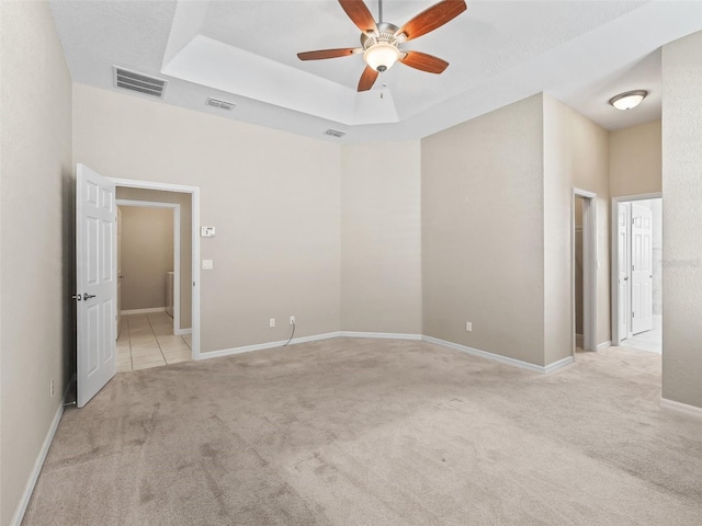 10927 SE 168th Loop, Summerfield, FL 34491 - empty room featuring light carpet, ceiling fan, and a raised ceiling