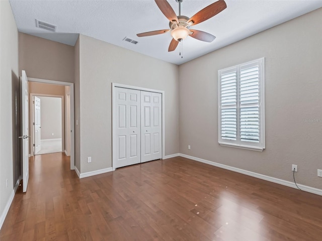 10927 SE 168th Loop, Summerfield, FL 34491 - unfurnished bedroom with wood finished floors, a closet, and a ceiling fan