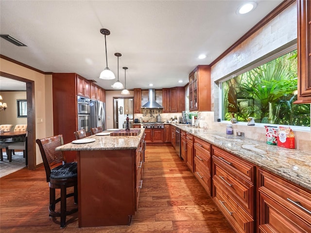 15733 Tower View Dr, Clermont, FL 34711 - kitchen featuring wall chimney exhaust hood, dark wood-type flooring, stainless steel appliances, light stone countertops, and crown molding