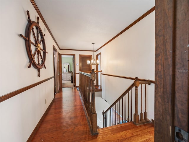 15733 Tower View Dr, Clermont, FL 34711 - hallway featuring an upstairs landing, a chandelier, wood finished floors, and ornamental molding