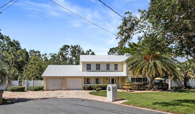 15733 Tower View Dr, Clermont, FL 34711 - traditional-style house with decorative driveway, a garage, and a metal roof