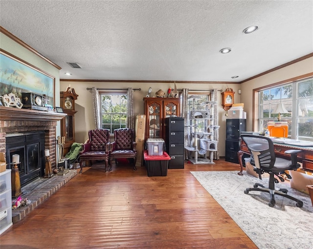 15733 Tower View Dr, Clermont, FL 34711 - office area featuring crown molding, hardwood / wood-style flooring, a textured ceiling, a fireplace, and recessed lighting