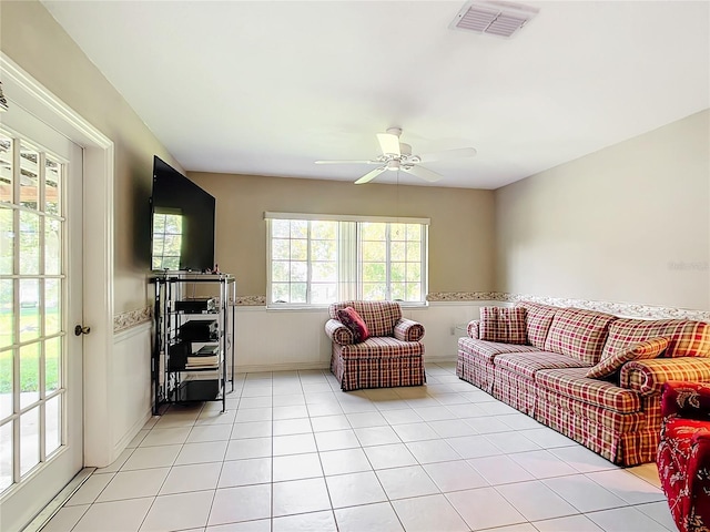 13700 SE 90th Ct, Summerfield, FL 34491 - living area featuring a ceiling fan, light tile patterned floors, and wainscoting