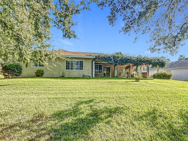 13700 SE 90th Ct, Summerfield, FL 34491 - view of front of property featuring stucco siding, a front lawn, and a pergola