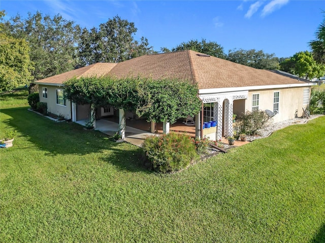 13700 SE 90th Ct, Summerfield, FL 34491 - back of house featuring a lawn, a patio, stucco siding, and a shingled roof