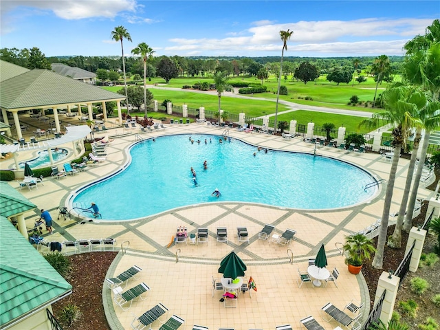 13700 SE 90th Ct, Summerfield, FL 34491 - community pool with a patio area, golf course view, and view of wooded area