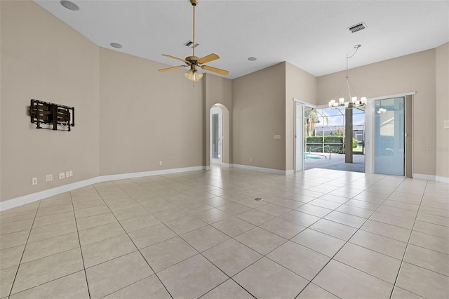 7303 Spring Mountain Ln, Yalaha, FL 34797 - spare room featuring a chandelier, light tile patterned flooring, arched walkways, ceiling fan, and a high ceiling