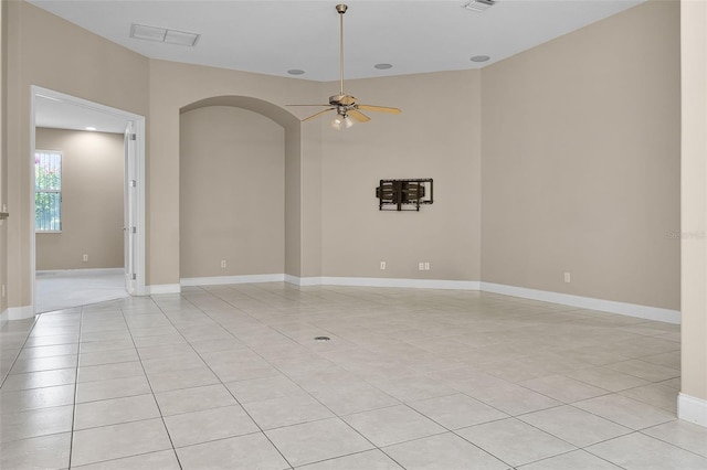 7303 Spring Mountain Ln, Yalaha, FL 34797 - unfurnished room with light tile patterned floors, arched walkways, and a ceiling fan