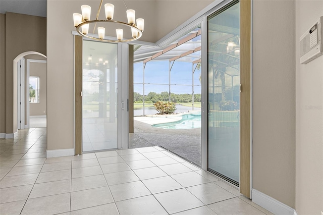 7303 Spring Mountain Ln, Yalaha, FL 34797 - entryway featuring arched walkways, light tile patterned floors, and a chandelier