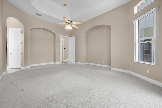 7303 Spring Mountain Ln, Yalaha, FL 34797 - spare room featuring arched walkways, carpet flooring, and ceiling fan