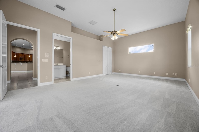 7303 Spring Mountain Ln, Yalaha, FL 34797 - unfurnished bedroom featuring light carpet, ensuite bath, and a ceiling fan