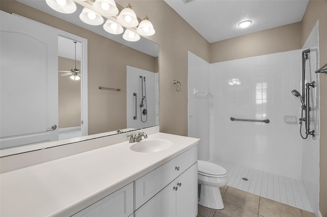 7303 Spring Mountain Ln, Yalaha, FL 34797 - bathroom with tiled shower, ceiling fan, vanity, and tile patterned floors