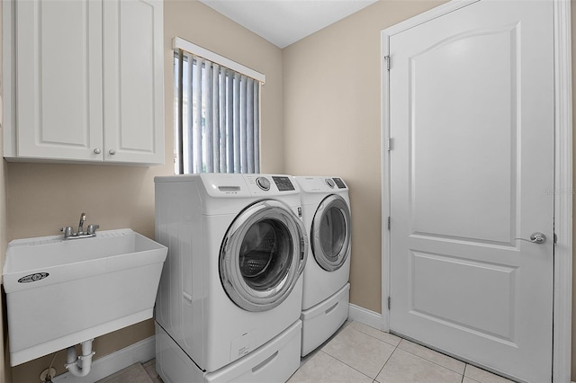 7303 Spring Mountain Ln, Yalaha, FL 34797 - washroom with washing machine and dryer, cabinet space, and light tile patterned floors