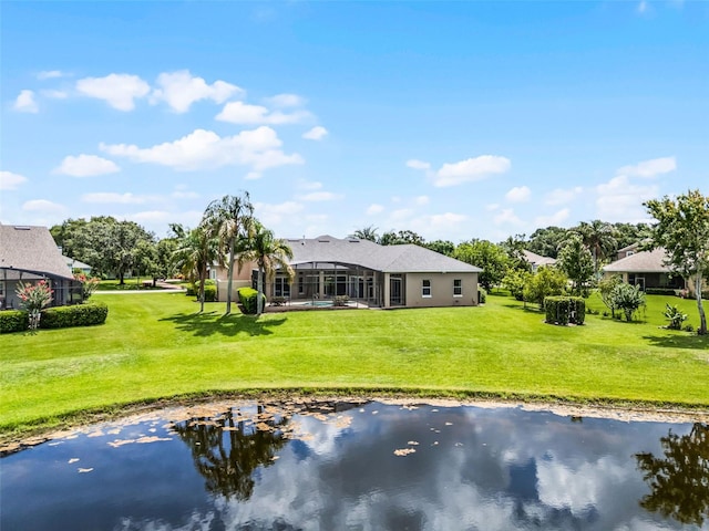 7303 Spring Mountain Ln, Yalaha, FL 34797 - back of property featuring a water view, a yard, and stucco siding